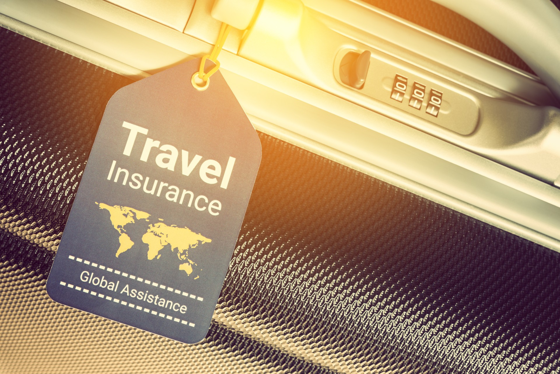 Travel safety and travel insurance concept : Travel insurance tag is hung near a numeric combination lock. Travel insurance is intended to cover lost luggage, trip cancellation, accident, losses, etc